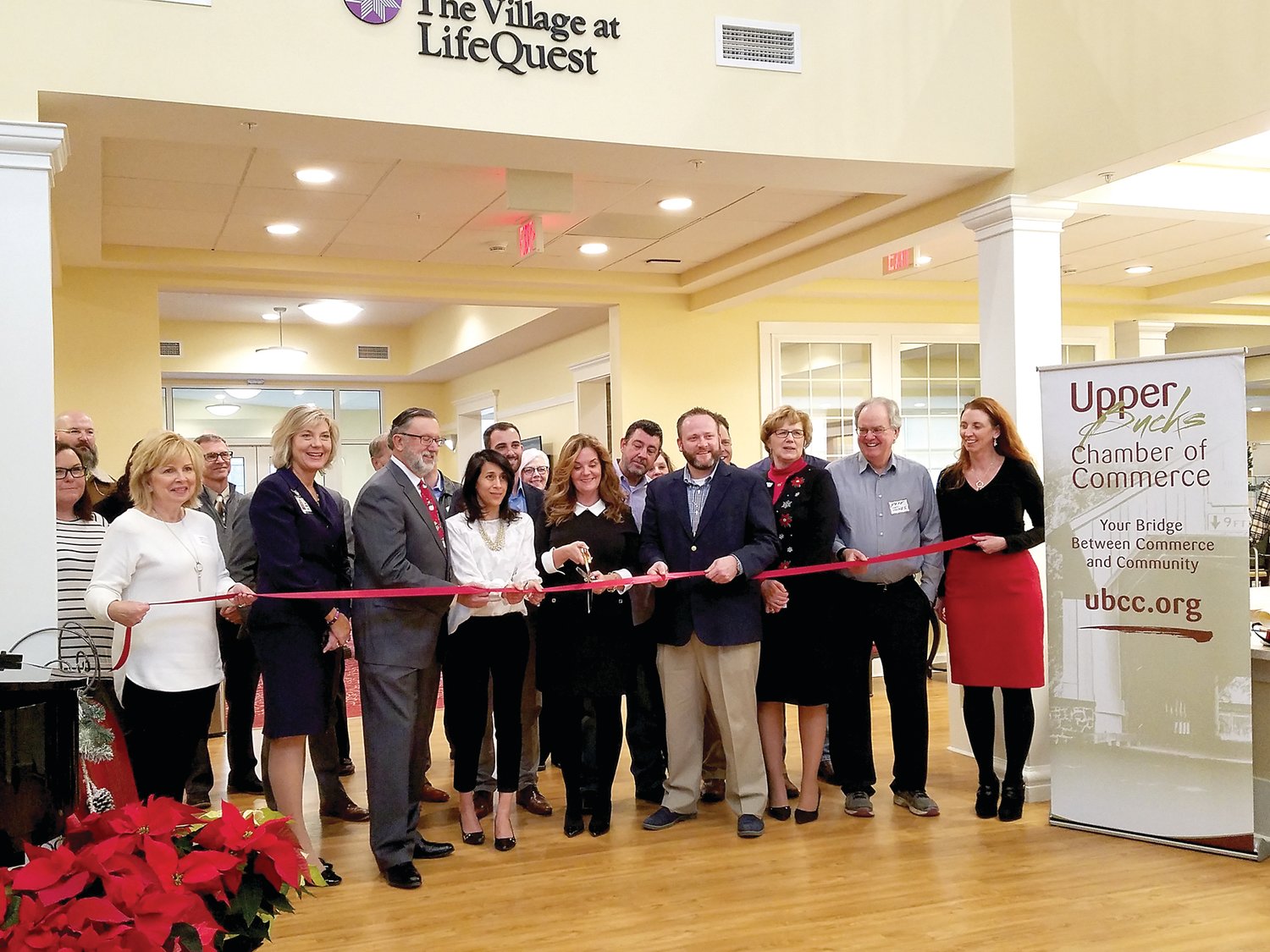 Quakertown Alive and Upper Bucks Chamber of Commerce were on hand to cut a ribbon Dec. 13 to kick off The Village at LifeQuest on Route 663 in Milford Township. Photograph by Melinda Rizzo.