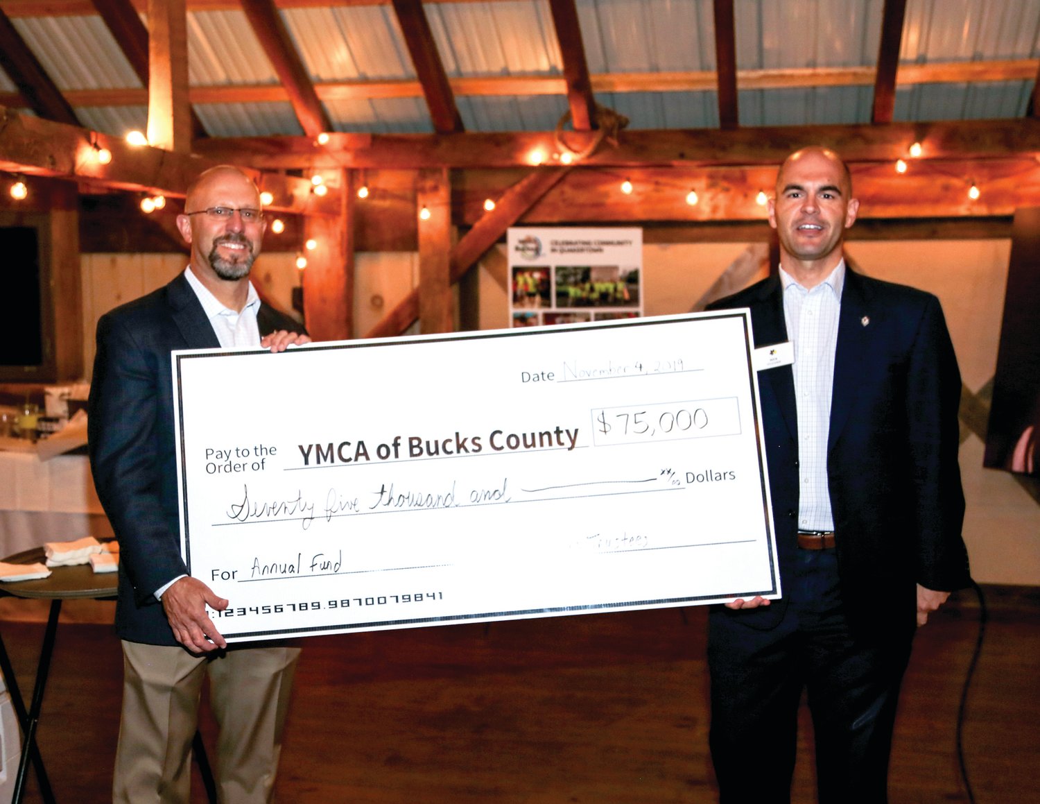 Zane Moore, president/CEO, and Nick Yelicanin, chief volunteer officer, both of YMCA of Bucks County, display the check representing the matching gift pledge.