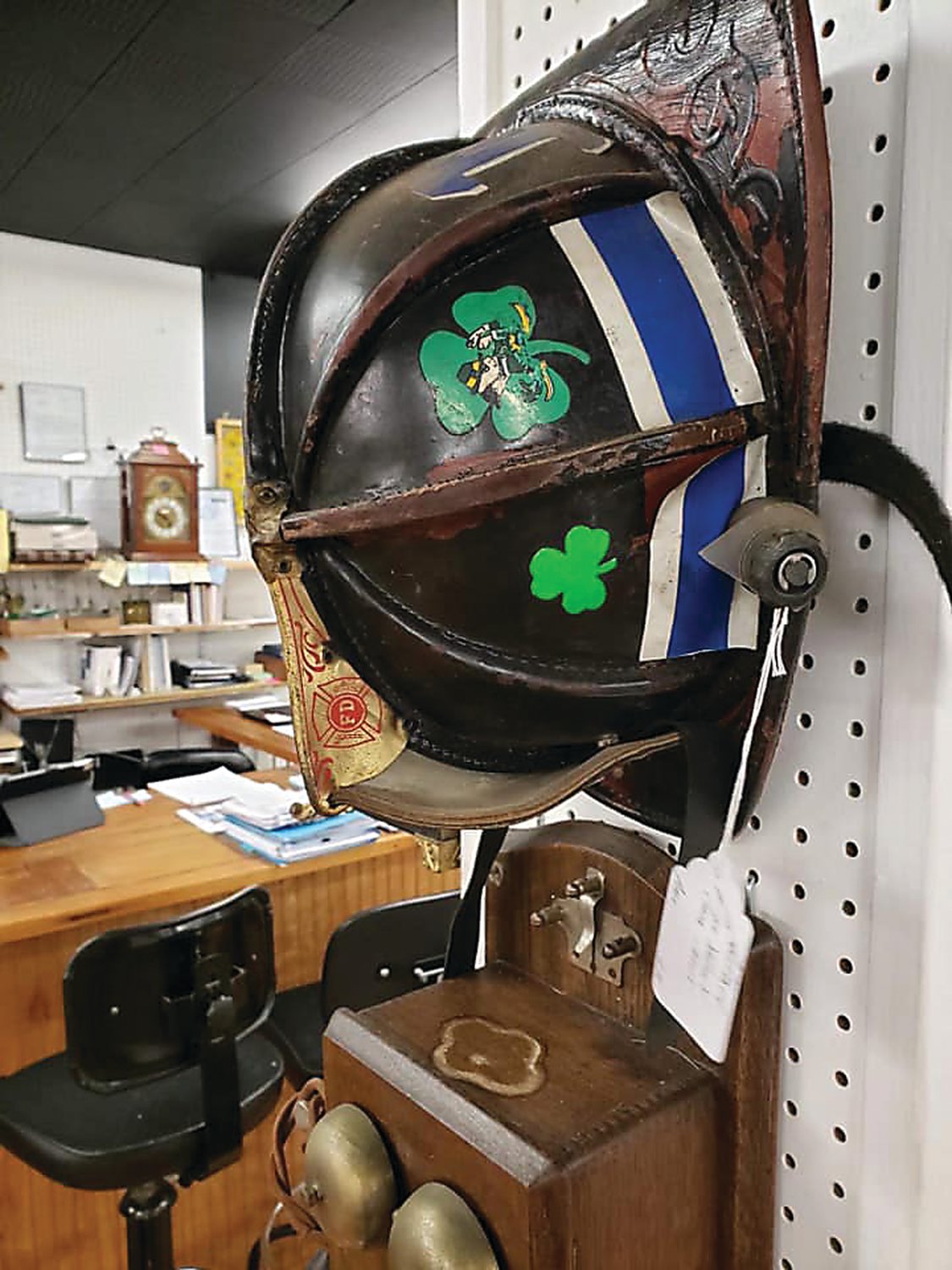Bud Baughman’s leather fire helmet bounced out of a fire truck as it headed for a demonstration 20 years ago. The helmet surfaced in an antiques shop, where his cousin spotted it.  Photograph by Joe Ferry.