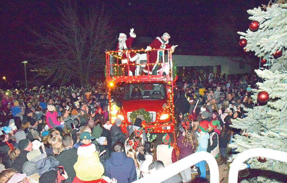 Santa and Mrs. Claus arrive on a Perkasie Electric truck.