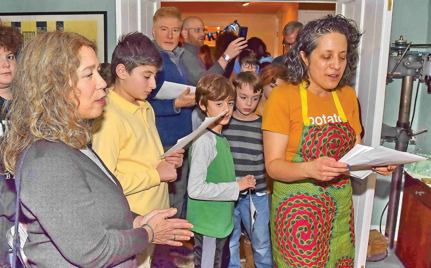 Rabbi Dianna Miller recites the traditional blessing over the menorahs. Photograph by Gordon and Libby Nieburg.