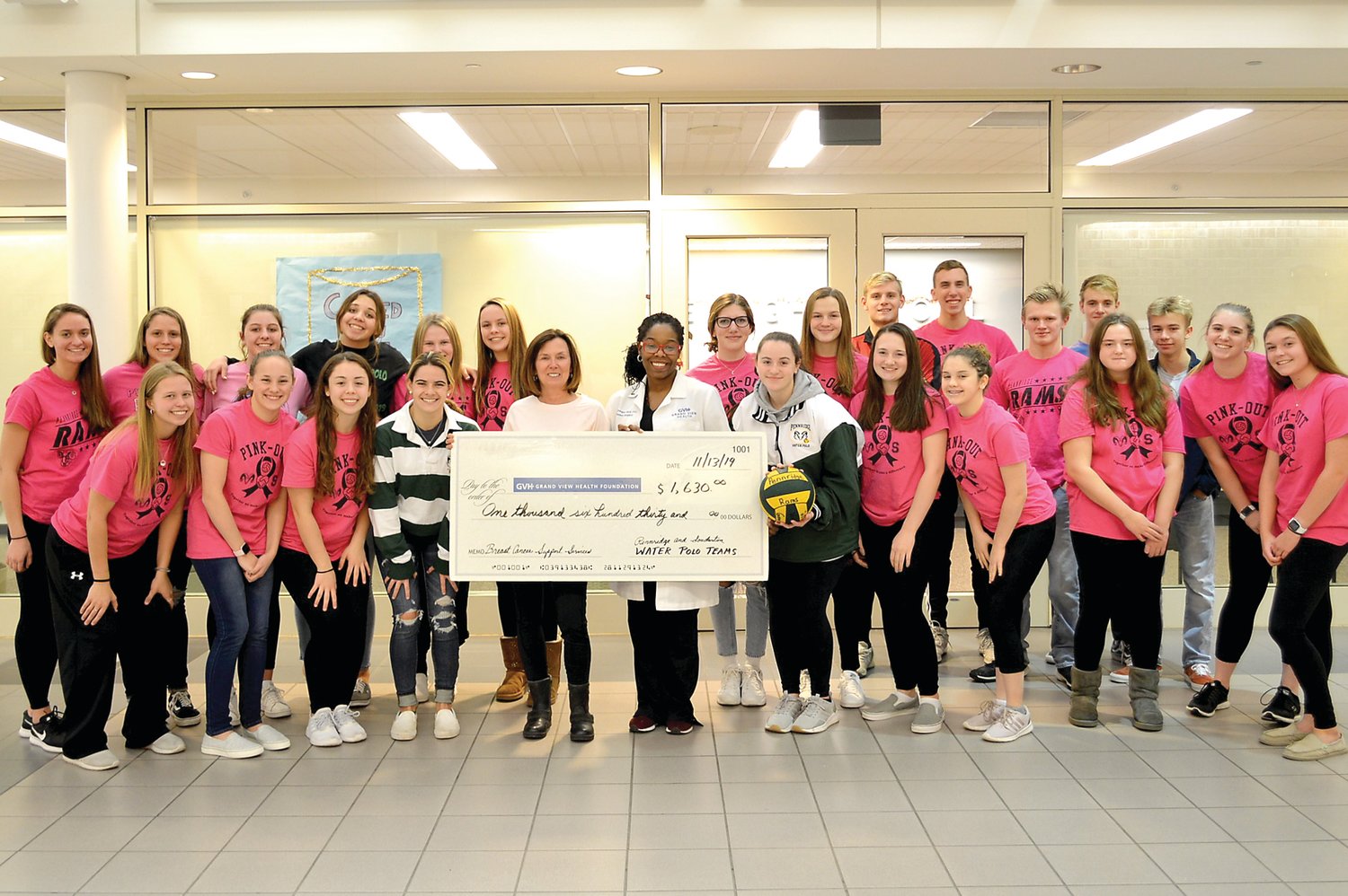 Members of the Pennridge and Souderton High School water polo teams join Vickie Keeler, executive director, Oncology Service Line, Grand View Health, and Dr. Monique Gary, breast surgical oncologist, Grand View Health, at the check presentation. Students, from left, are: front row, Halle Casper, Raegan Vesey, Lea Preston, Hope Garges, Kerry Miller, Ava Conolly, Alysha Eby, Summer Stephens, Lindsay McMackin, Hannah Christie; back row, Abby Nuneviller, Samantha Ackley, Hannah Keyser, Hannah Sayre, Tess McLaughlin, Ady Garges, Samantha Darrell, Lauren Scott, Will Leyland, Kristian Stanczewski, Liam McLaughlin, Zachary Yardley and Jack Pearson.