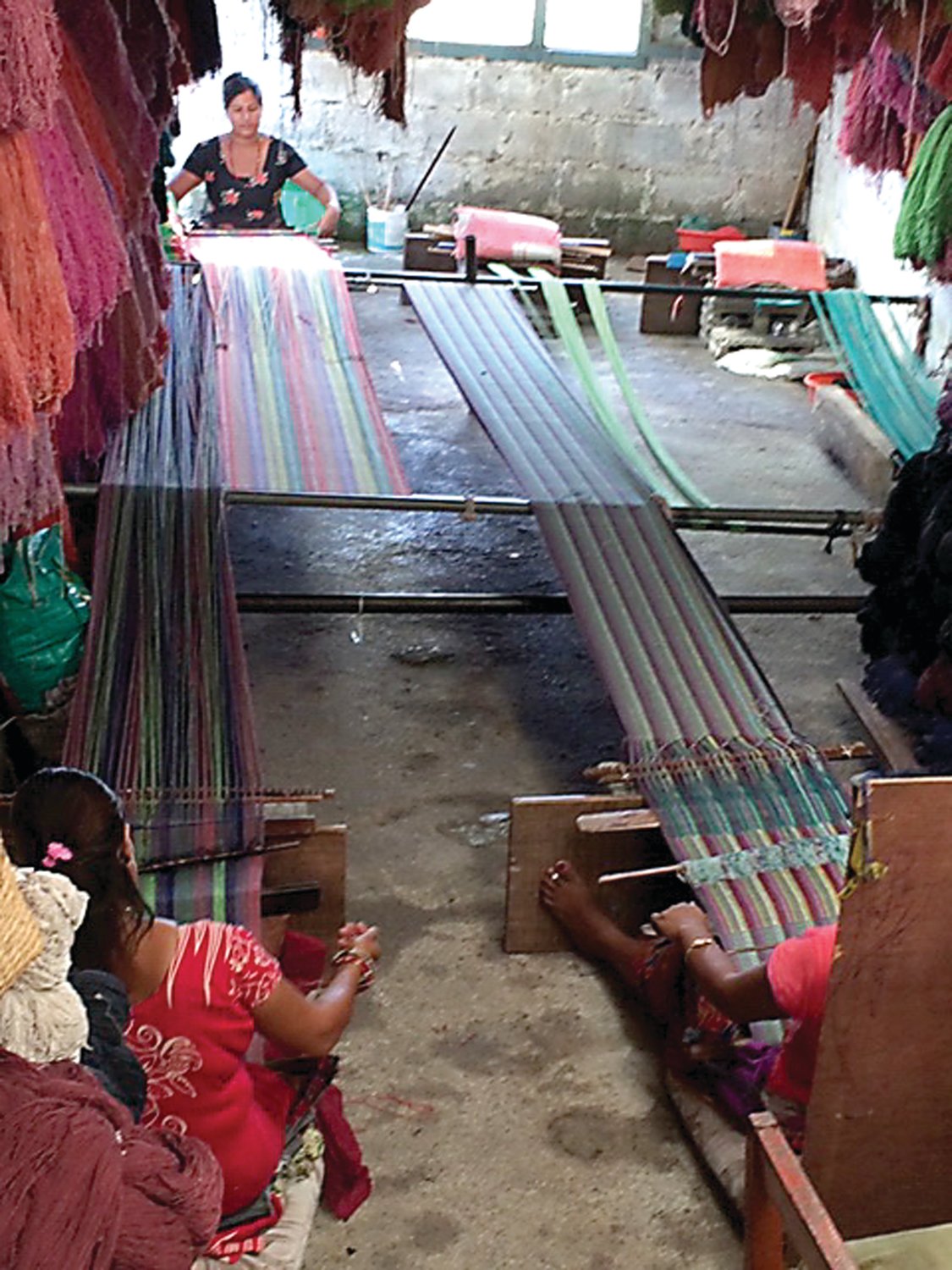 Nepali women work on a loom in one of the women’s training centers established with the help of Maria Santangelo, Pine Run Retirement Community’s executive director. She has formed the Ama Chhori Foundation of Hope to further help Nepali women and girls. Photograph by Maria Santangelo .