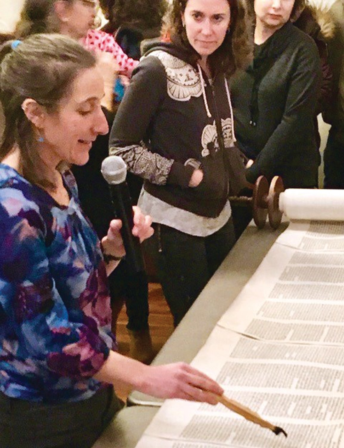KHN member Steffany Moonaz and other congregants look on as scribe Julie Seltzer points out special details of KHN’s new Torah.