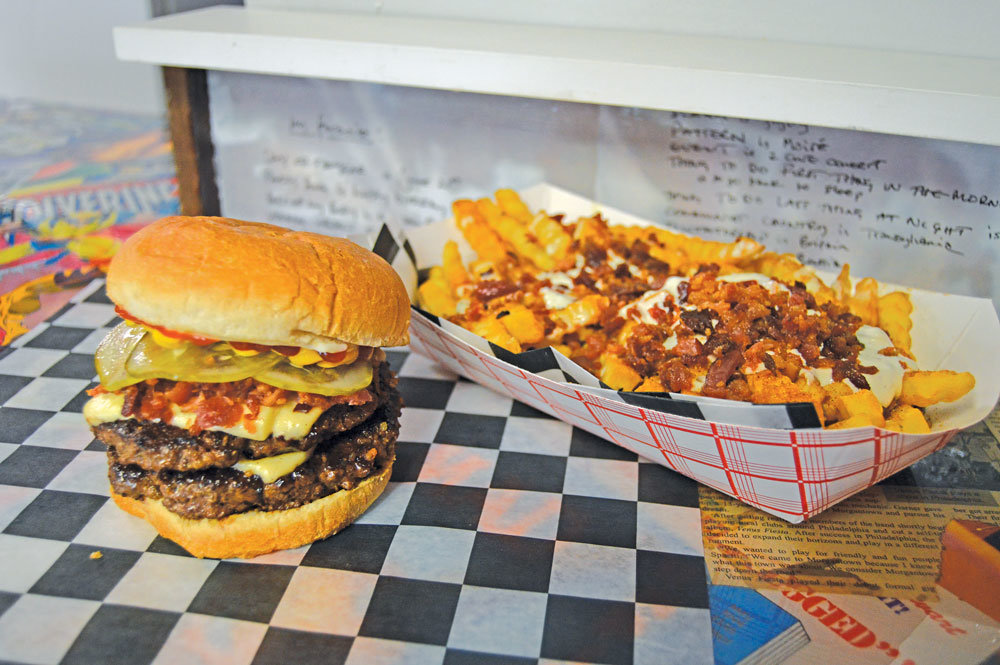 A double cheeseburger with a side of Weird Science Fries is a popular choice at Old School Burgers in Willow Grove and Ambler. Photograph by Susan S. Yeske.