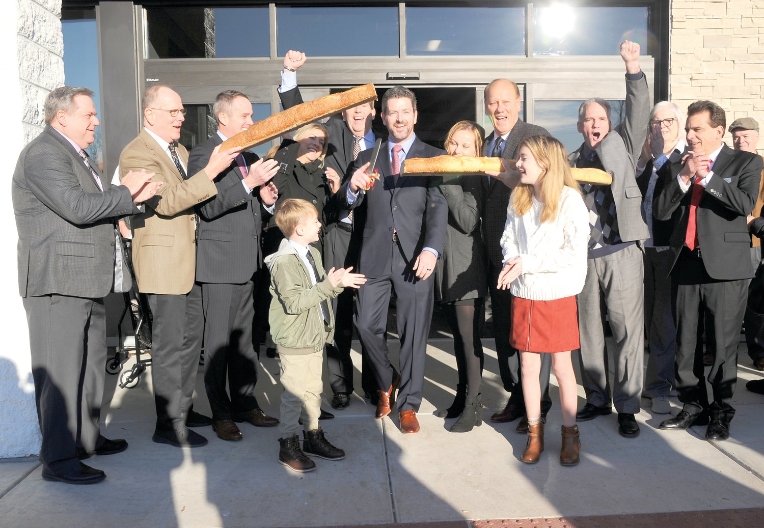 Participating in the “bread cutting” for McCaffrey’s Food Markets’ New Hope store are Thomas Tilley, human resources director; Fred Brohm, COO; state Sen. Steven Santarsiero; Lisa McCaffrey,  James McCaffrey V, James McCaffrey IV, James McCaffrey III, Maggie McCaffrey, New Hope Mayor Larry Keller, Grace McCaffrey, Mike Esbensen, assistant store manager; Maryann Vernon, director of store operations; and Lou Campo, store manager. Photograph by Carol Ross.
