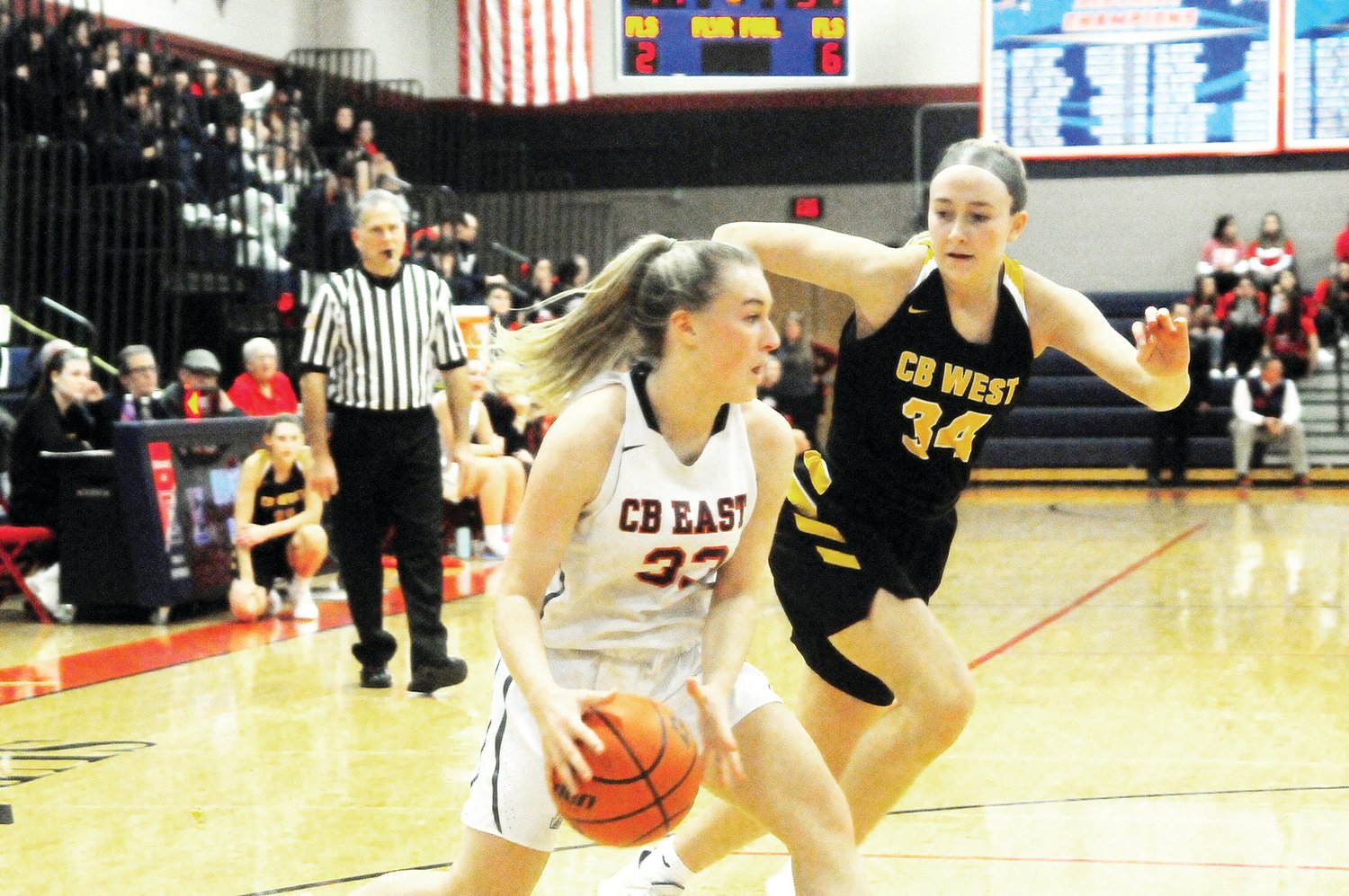 Central Bucks East junior Emily Barry, 33, left, drives the baseline, defended by CB West senior Maddy McGarry, 34, right. Photograph by Steve Sherman.