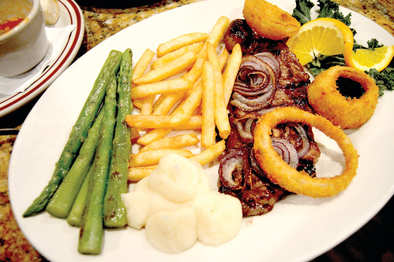A New York strip steak is topped with onions and onion rings at the New Hope Star Diner. Photograph by Susan S. Yeske.