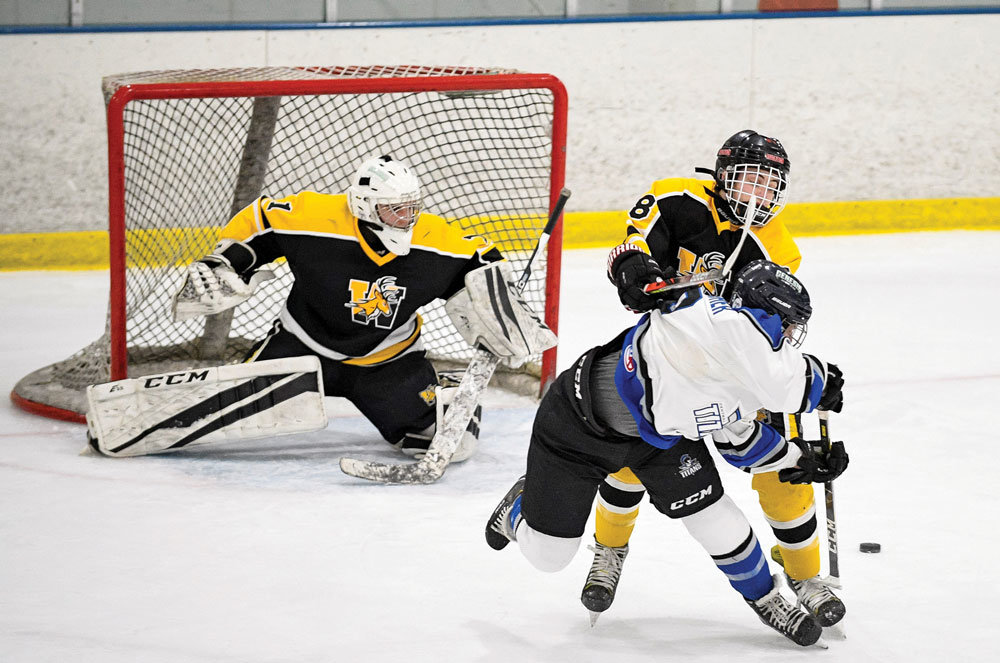 CB South’s Daniel Kvecher pivots, spins and wraps a backhand shot for a goal. Photograph by Michael A. Apice.
