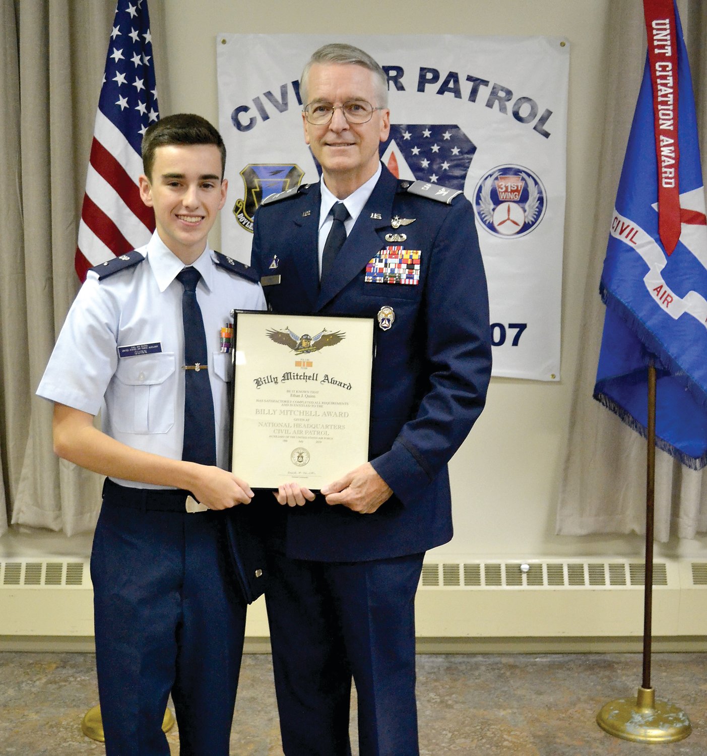 Cadet 2nd Lt. Ethan Quinn Ethan Quinn accepts the Billy Mitchell Award from Col. Kevin J. Berry, commander of the Pennsylvania Wing of the CAP. Photograph by C. Quinn.