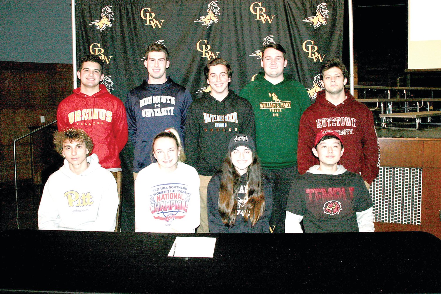 At the Central Bucks West letter signing ceremony are, from left, front row, Luke Cimakasky (Pitt Johnstown), Ryan Kelly (Florida Southern), Alexa Vail (Moravian), Jimi Leder (Temple); back row, Tristan Hulme (Ursinus), Jack Neri (Monmouth), Ryan Van Pelt (Widener), Ryan McKenna (William & Mary) and Jack Fallon (Kutztown). Photograph by Mary Jane Souder.