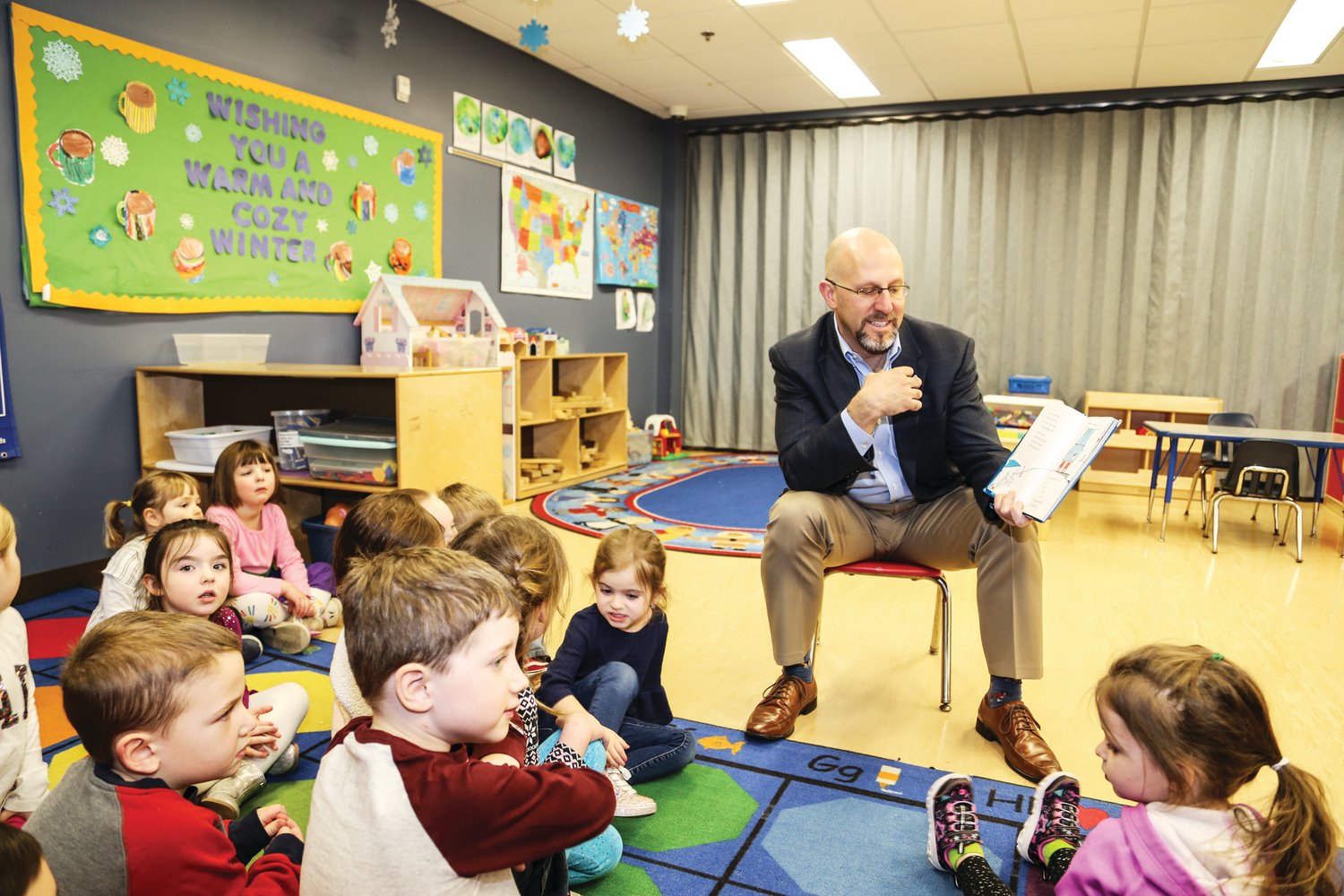 Zane Moore, president/CEO of YMCA of Bucks County, reads to youth at the Y’s Quakertown-based child care center as part of “Read Across America” week.