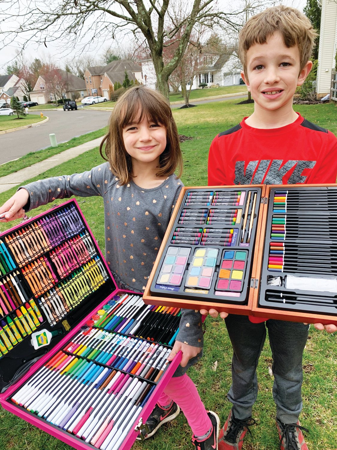 Emma and Henry Doone with their art supplies getting ready to spread some sunshine.