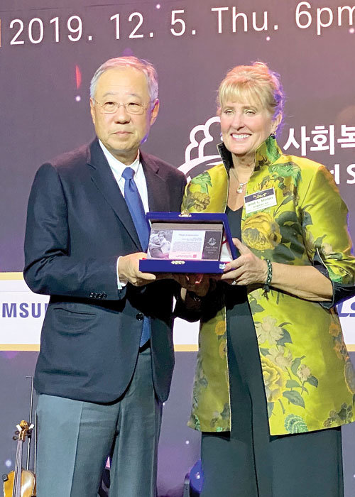 Pearl S. Buck International President and CEO Janet Mintzer receives an award from Jin Roy Ryu,  chairman of the board of the Pearl S. Buck Foundation in Korea. Mintzer will retire from PSBI in May after 20 years of service.