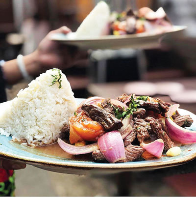 Peruvian comfort food includes this dish, Lomo Saltado, which features steak or other protein cooked in wine and combined with French fries.  Photograph by El Tule/Quinoa.