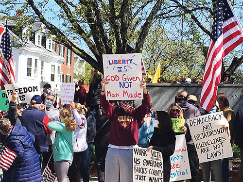 Demonstrators gathered  near the former courthouse in Doylestown Wednesday. They called for businesses to be allowed to reopen.