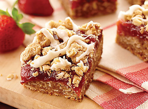 Seasonal strawberries and rhubarb come together to make a variety of dishes and desserts including these dessert bars. Photograph by Landolakes.com.