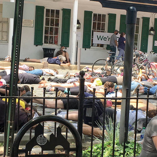 Protestors lay down, chanting, “ I can’t breathe,” during a peaceful demonstration in Doylestown Monday. The protest was centered on police brutality against black Americans and the alleged murder of George Floyd by Minneapolis police. Floyd repeatedly told the officer, who had his knee braced into his neck, that he couldn’t breathe. Photograph by Freda R. Savana.