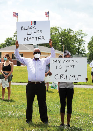 Protesters hold up signs in Quakertown. Photograph by Michael Ast.
