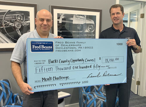 Chris Gilbert, right, director of operations for the Fred Beans Automotive Group, presents a check for $15,150 to Joseph Cuozzo, director of development for the Bucks County Opportunity Council, which represents the company’s May contribution to the BCOC as part of the Fred Beans 500,000 Meals Challenge. Cuozzo said that the organization received another $2,687 in individual contributions made through a special donation page established for those wanting to help meet the 500,000-meal goal.