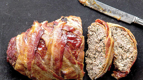 Meatloaf, a favorite of many dads, as an entrée for Father’s Day gatherings. This version is wrapped in bacon. Bonappetit.com photo by Alex Lau Consider.