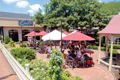 Families dine on the patio outside Earl’s New American in Peddler’s Village.