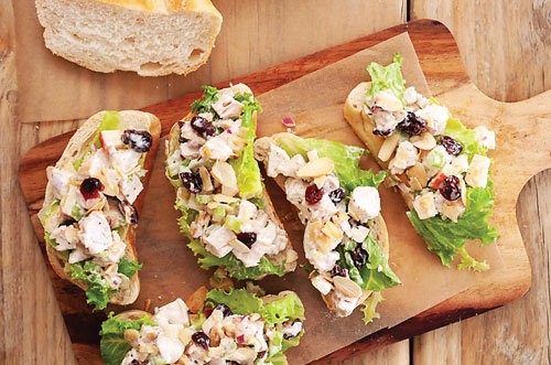 Chicken salad is a great summertime entrée; this one includes cranberries with the option of adding curry powder. Photograph by Thespruceeats.com.
