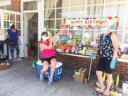 Pantry volunteers Amelia Barragan, Stephanie Leister and Annette Antolik celebrate outside the Delaware Valley Food Pantry in the CVS Shopping Center in Lambertville, N.J.