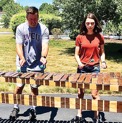 Kaitlyn Zajkowski and her dad, Edward, play the marimba they built together.
