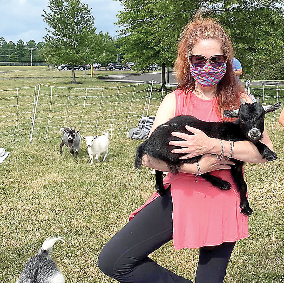Meg McSweeney practices “Goat Yoga,” one of several programs being offered this month to bid farewell to the David Library.