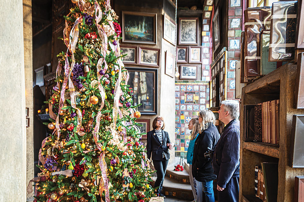 Visitors look at a decorated tree during a prior holiday tour at Fonthill Castle.