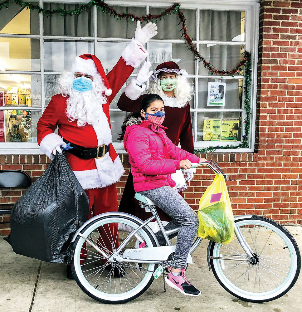 Santa and Mrs. Claus hand out gifts. (DEBRA GARVEY)