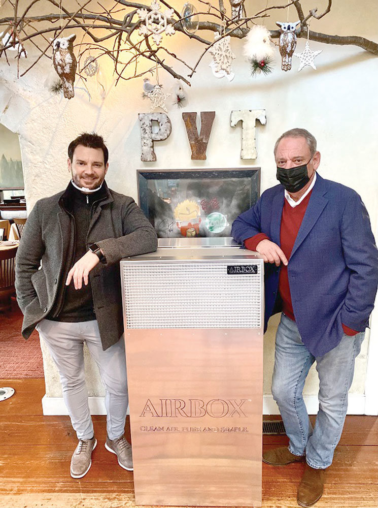 Phil and Andrew Abruzzese with their new air purifier, next to the host station.
