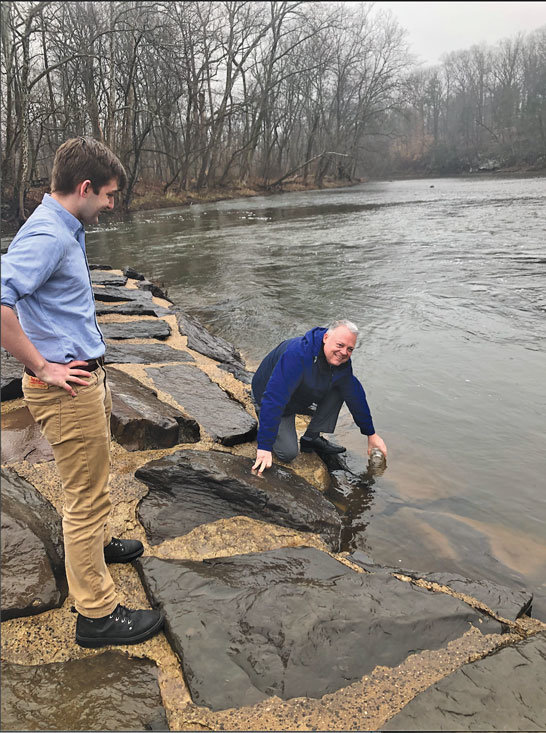 PennEnvironment Research & Policy Center conducted a study of 53 waterways in Pennsylvania, including the Delaware and tributaries. State Rep. Perry Warren, right, collects a sample from the Neshaminy Creek at Tyler Park. (Hannah Pittel)
