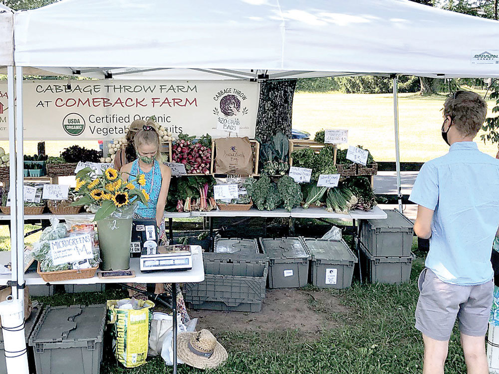 A customer is ready to shop at the Cabbage Throw Farm at Comeback Farm stand at the Hunterdon Land Trust Farmers’ Market.