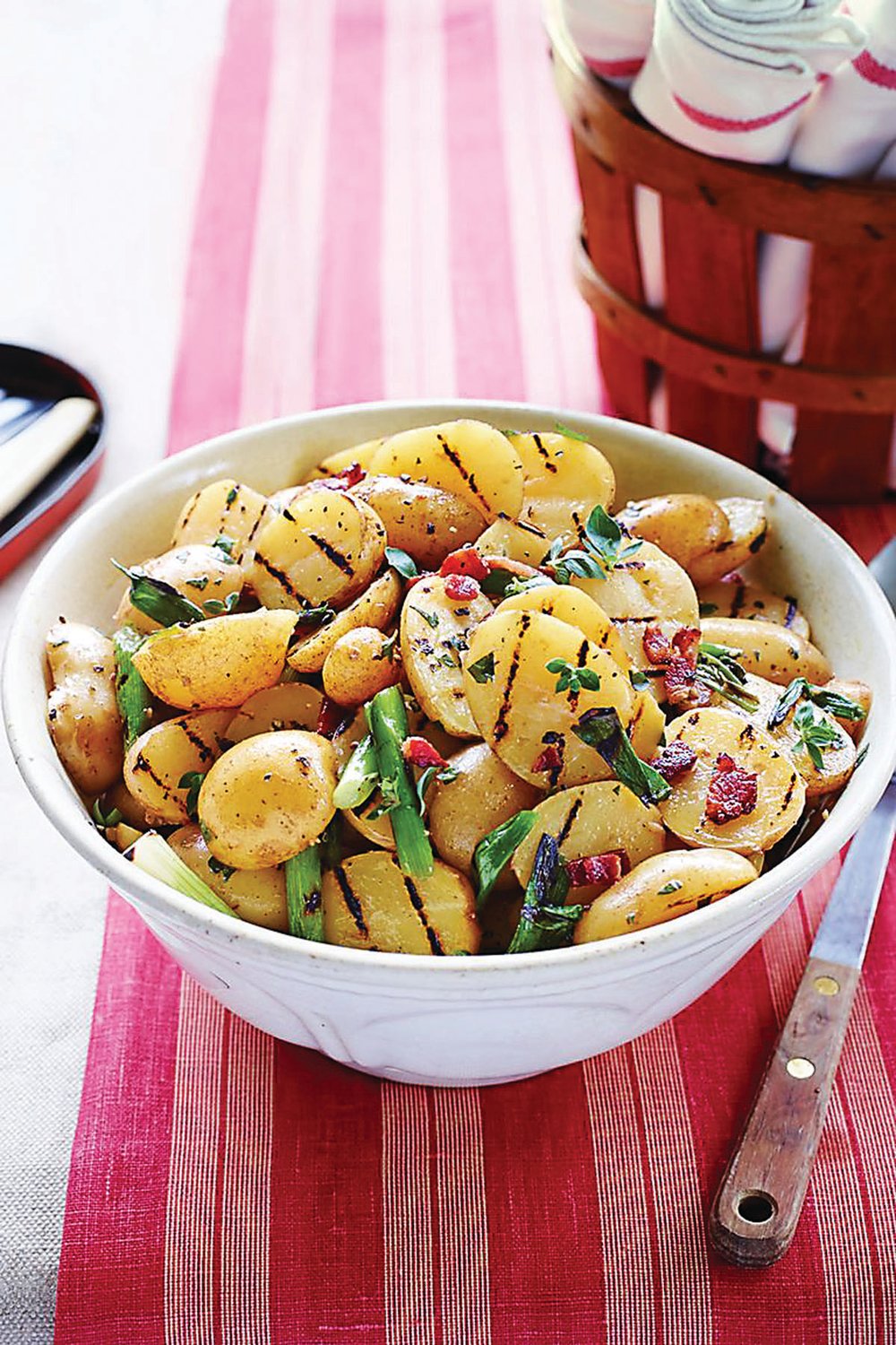 For something a little different for Memorial Day picnics, this warm salad includes potatoes that are boiled, then briefly grilled and finished with bacon vinaigrette.