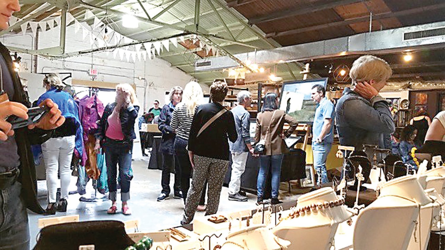 Visitors to a prior Flemington Fine Artisans Show explore the arts and crafts created by local artists.