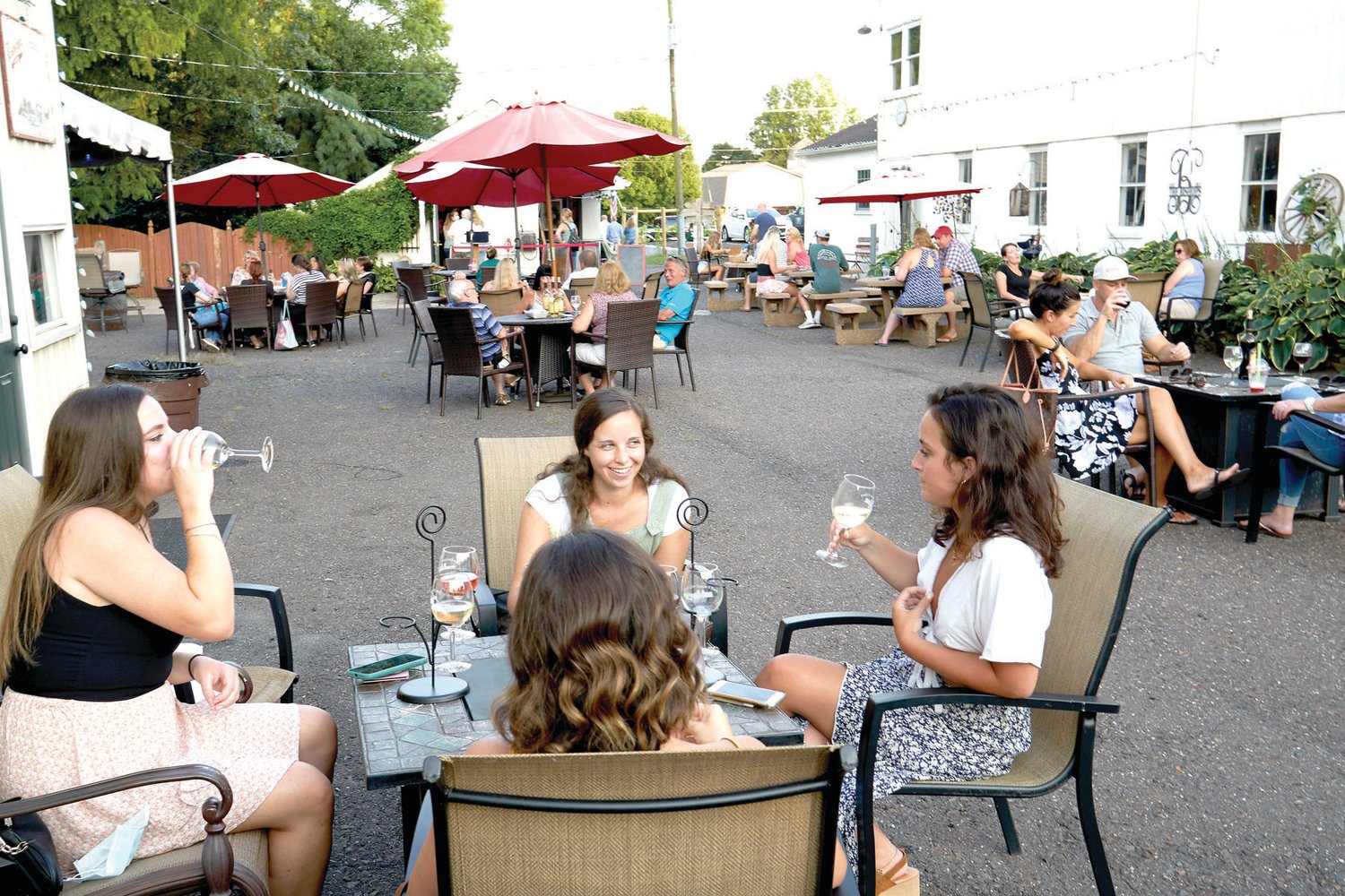 Visitors enjoy a drink outdoors at one of the wineries along the Bucks County Wine Trail.
