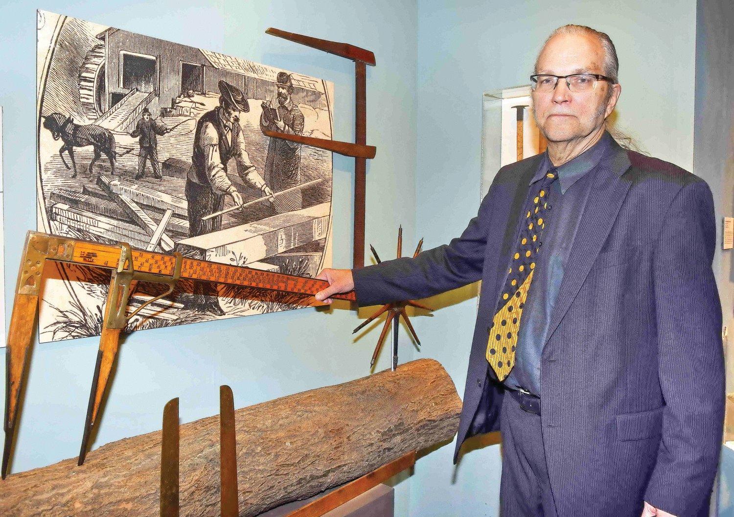 Jim Hill with a log measuring device.
