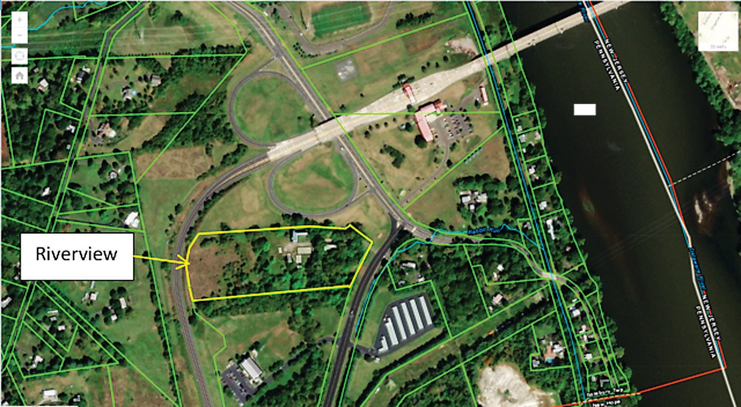 An aerial view of the land to be developed is marked with a yellow border.