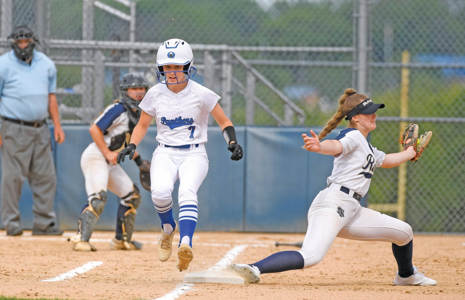 Quakertown’s Emma Hilton beats out an infield hit in front of Spring-Ford’s Madison Peck.