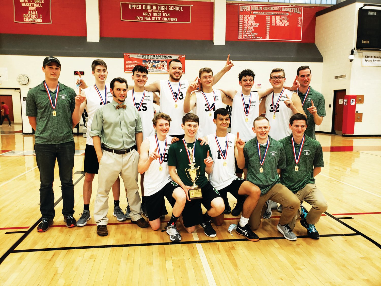 Members of the Pennridge boys volleyball team pose with the District One Class 3A trophy.