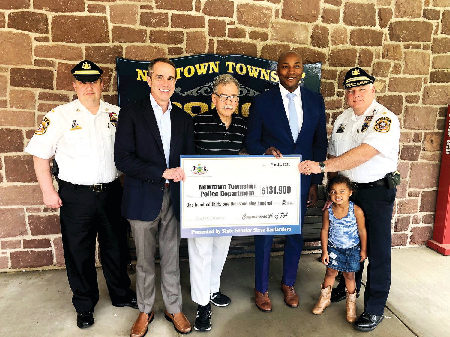 Members of the Newtown Township Police Department and Supervisor David Oxley receive a check from Sen. Santarsiero.