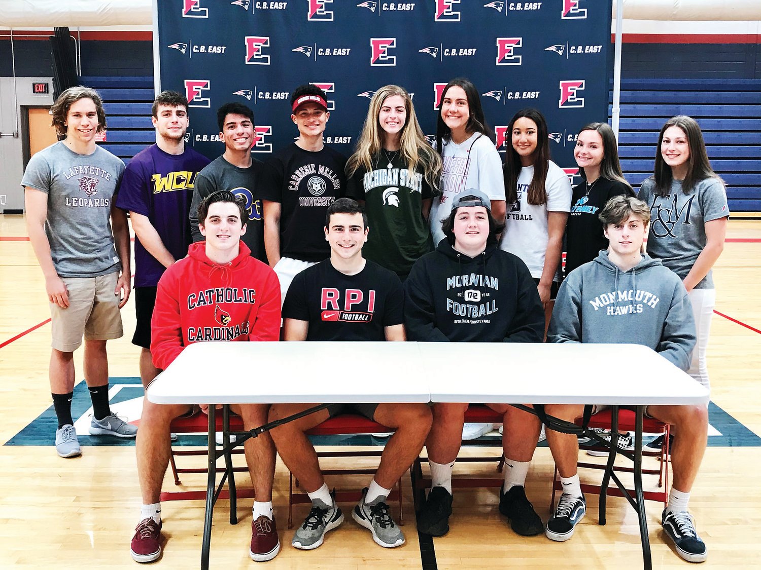CB East seniors who were recently recognized for committing to compete in collegiate sports are, from left, back row, Tommy Krystkiewicz, Joe Jackman, Marcos Lopez, Luke Blackwell, Olivia Portner, Emily Chmiel, Soleil Dooner, Isabella Mignon, Sophie Moyer; front row,  Anthony Giordano, Mark Lapioli, Reins Leedy and Will Silverman.