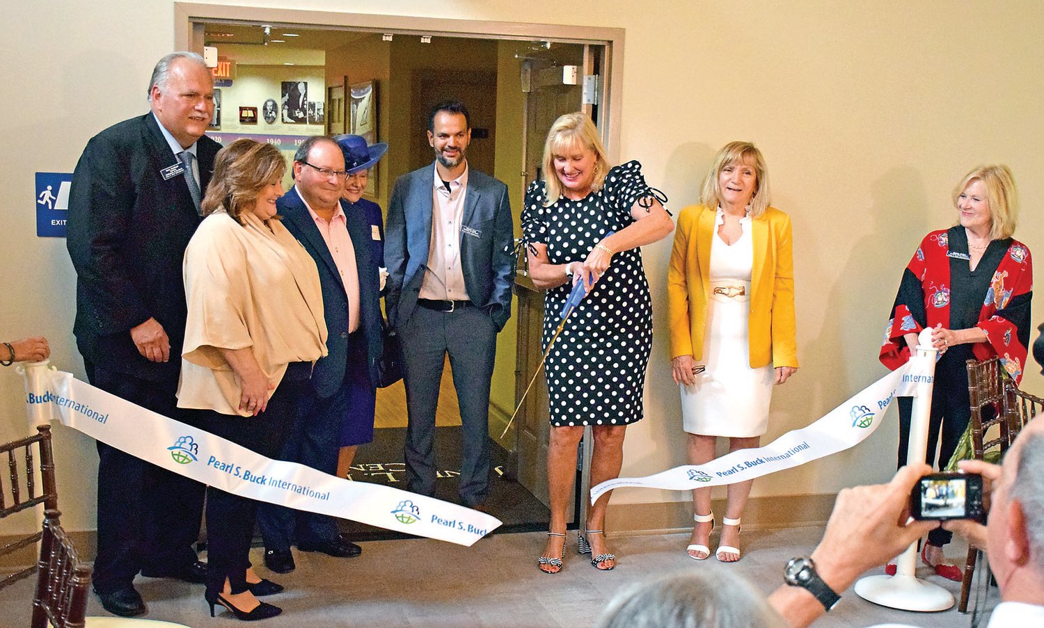 Janet L. Mintzer, emeritus president and CEO, cuts the riboon at the grand opening celebration of Pearl S. Buck International’s newly renovated events center, named in Mintzer’s honor.