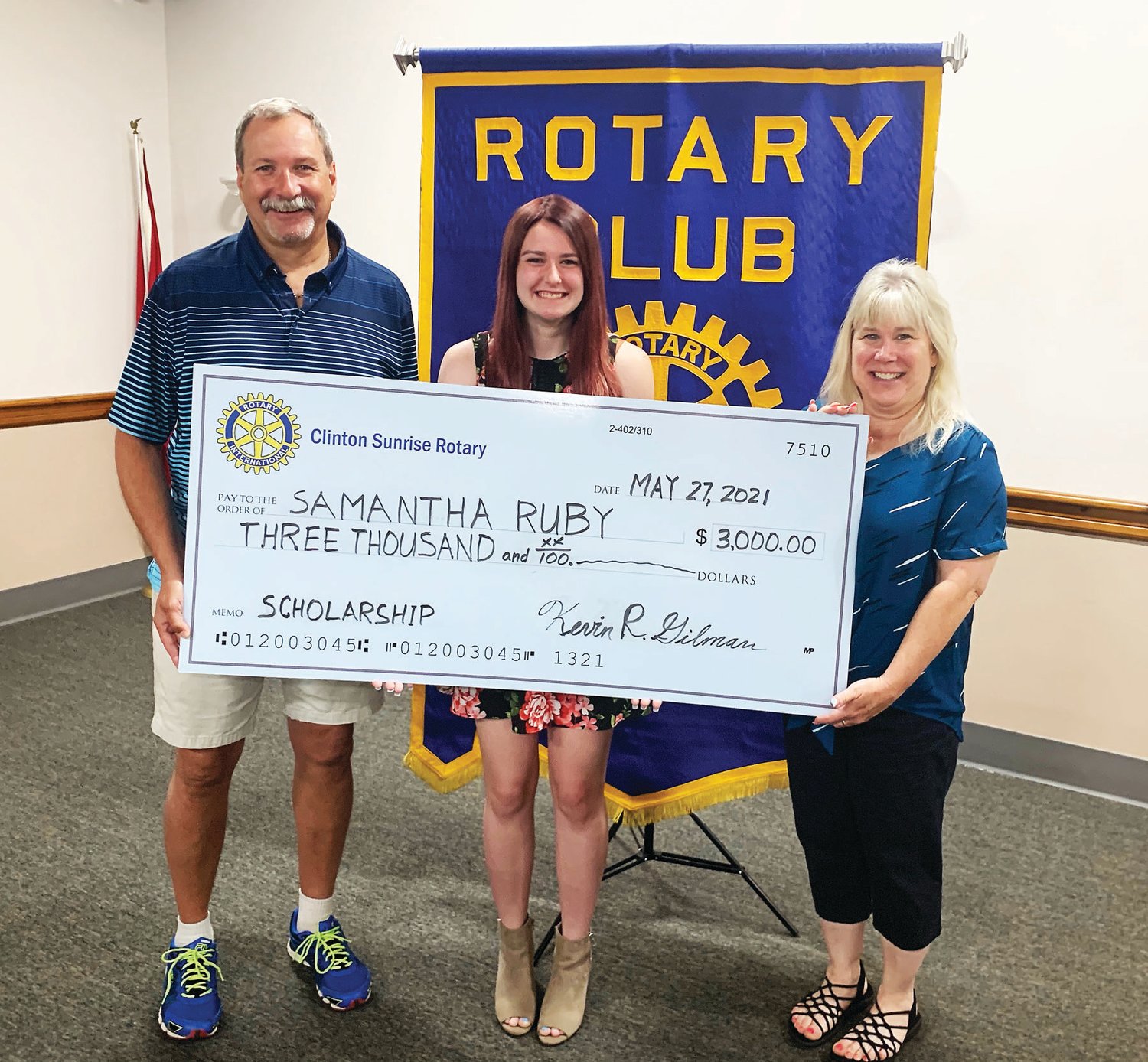 Hunterdon County Polytech pre-nursing senior Samantha Ruby, center, receives a scholarship from Clinton Sunrise Rotary flanked by her parents, Richard, left, and Beth, right.