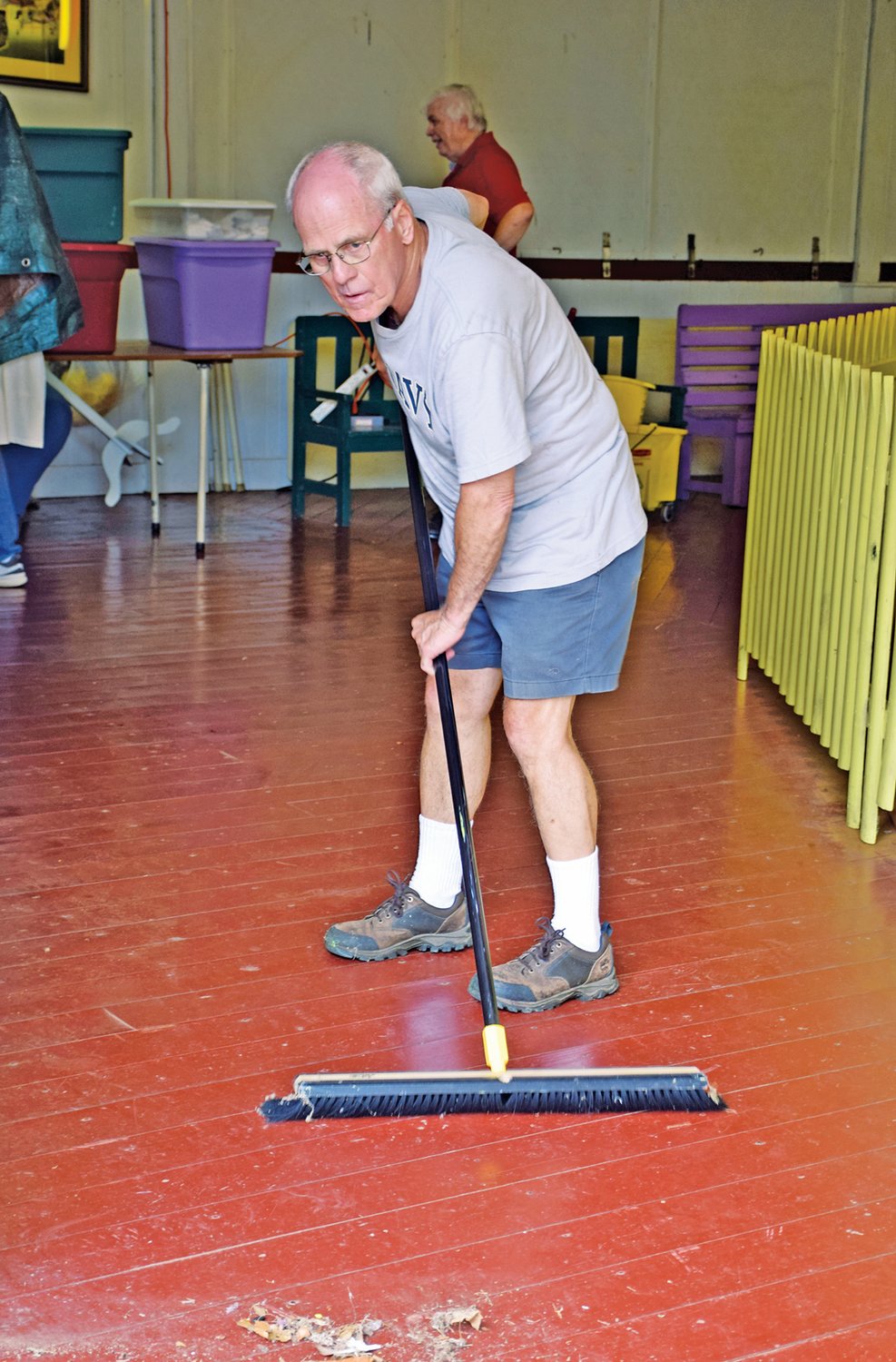 Perkasie Historical Society Treasurer Jerry Treffinger sweeps the floor of the carousel.