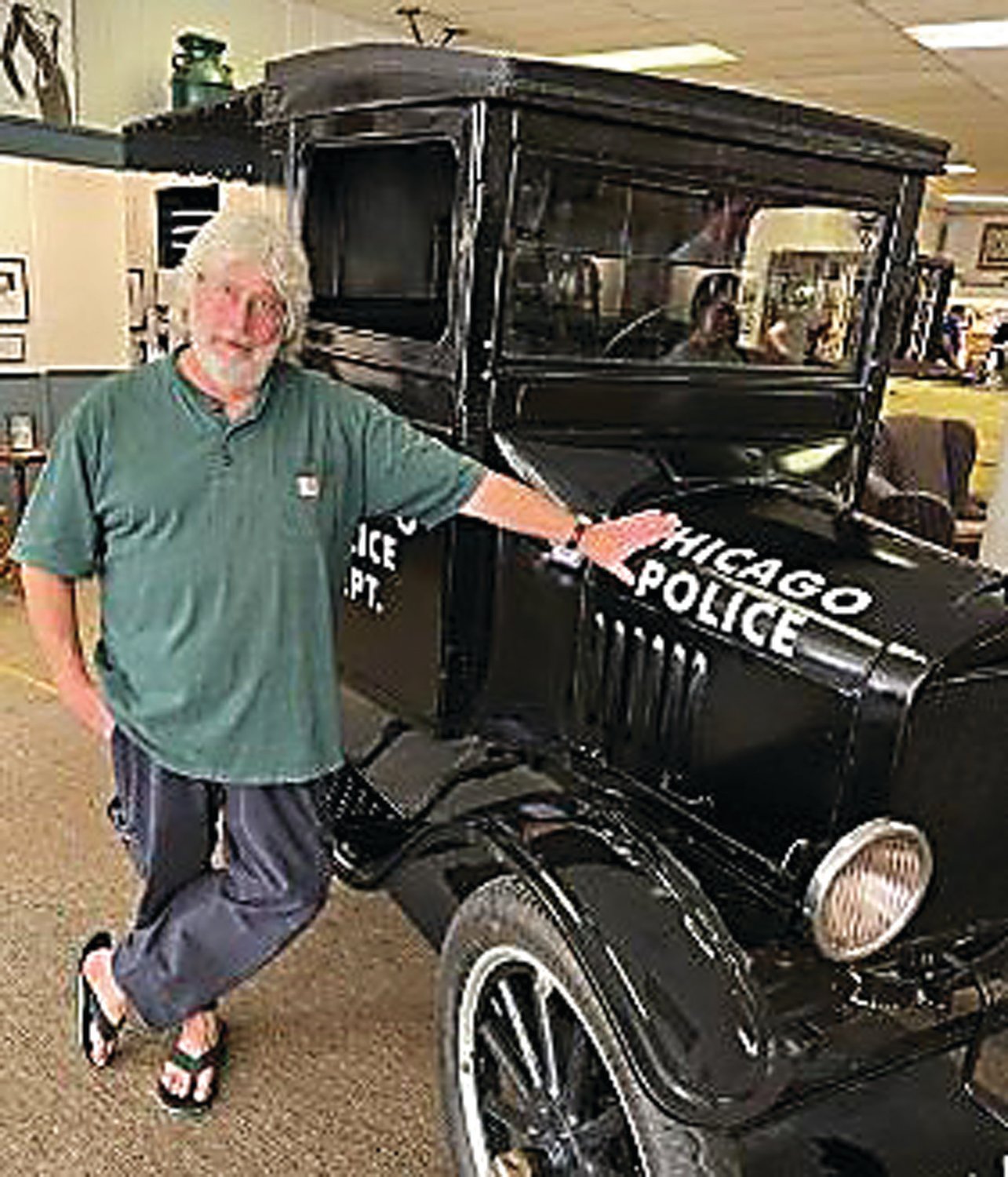 Stephen Green, president and CEO of the Eliot Ness Museum, and a re-imagined Chicago paddy wagon from the Prohibition Era.