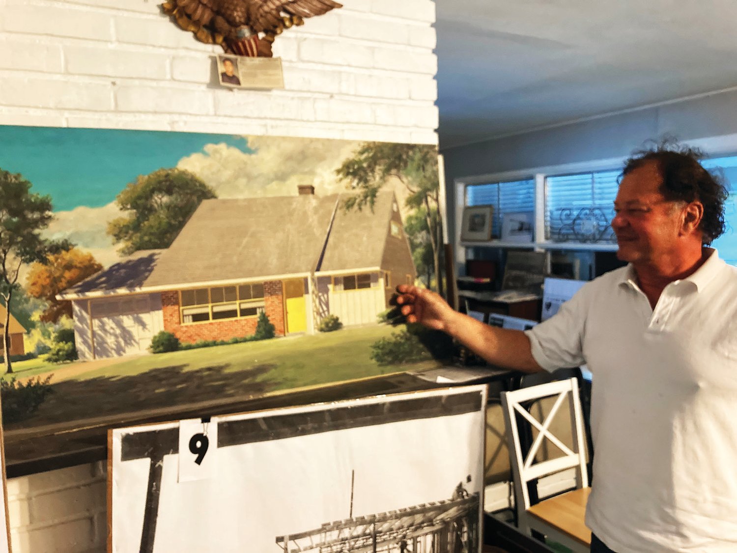 David Marable points to one of the original prints of Levittown house models, part of his vast Levittown collection.