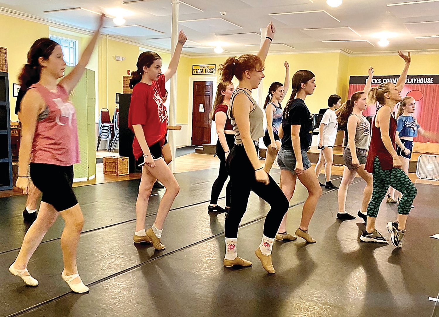 Choreographer Dani Tucci-Juraga (front, burgundy top) teaches Youth Company members dance moves.